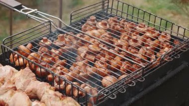 Lezzetli, iştah açıcı biftek eti dışarıda ateşte ve dumanda kızarıyor. Yaz tatilinde arkadaşlarla ızgarada şiş kebap. Kömürlü ızgara ızgara. Yüksek kalite FullHD