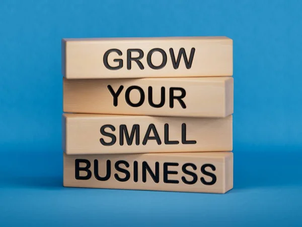small business ' small small ' ' ' ' ' ' ' made of small small wooden blocks on a blue board. business, beautiful business,