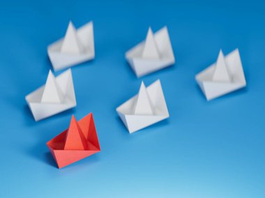 Farklı iş anlayışı. Yeni fikirler. Kağıt sanatı. Beyaz teknelerin arasında liderlik kavramı. Mavi arka planda 3 boyutlu..