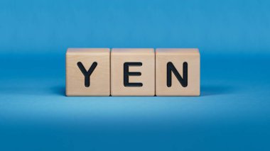 Yen iş sözcüğüyle ahşap küp bloğu. Ahşap elementlere yakın plan, mavi arkaplanda 3D İş Konsepti.