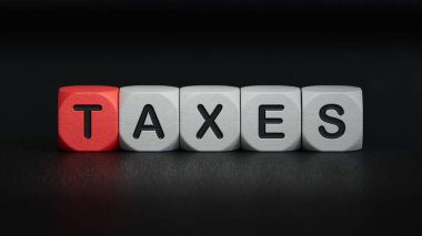 Tahta küp bloğu, vergilerle ilgili kelime. Ahşap elementlere yakın çekim, siyah arkaplanda 3D iş konsepti..