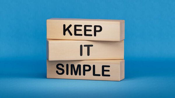 Keep it Simple symbol. Concept words Keep it Simple on wooden blocks.Business and Keep it Simple concept. Copy space.3D rendering on blue background.