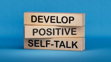 Develop positive self-talk symbol. Concept words Develop positive self-talk on wooden blocks.Business and Develop positive self-talk concept.3D rendering on blue background. clipart