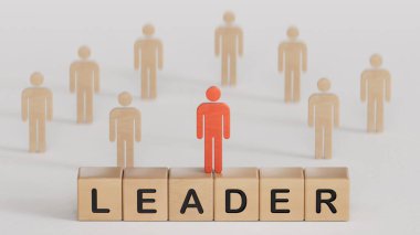 Liderlik ve takım lideri konsepti. Tahta bloktaki kelime ekibi, tahta bir blokta Lider 'le birlikte duran tahta figür. Başarı için işbirliği ve liderlik ilişkisi. İş konsepti.