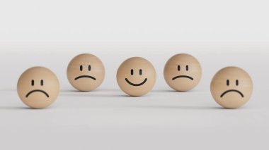 Beyaz arkaplanda oluşturulan duygu anlayışı ve müşteri hizmetleri değerlendirmesi için üzgün yüz ifadeleri arasında tahta top bloğunda gülen yüz yazdırma ekranı.