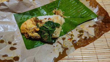 Nasi Padang in a package, already opened, ready to eat clipart