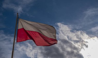 Gökyüzünün arka planında beyaz ve kırmızı Polonya bayrağı
