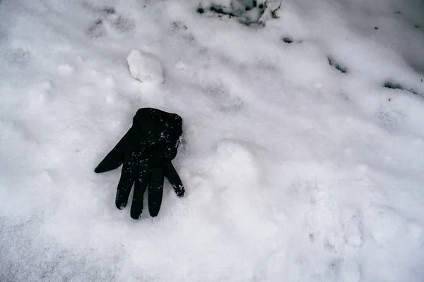 Lost mitten in the snow. A lost item of clothing