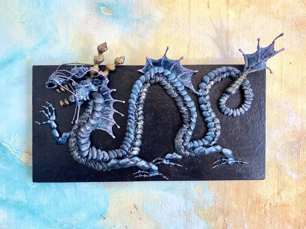 Chinese sea dragon. Decorative panel, red background