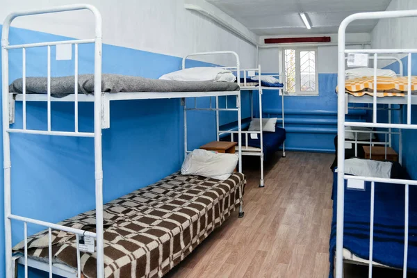 Interior of a prison cell with bunk beds and bunk beds