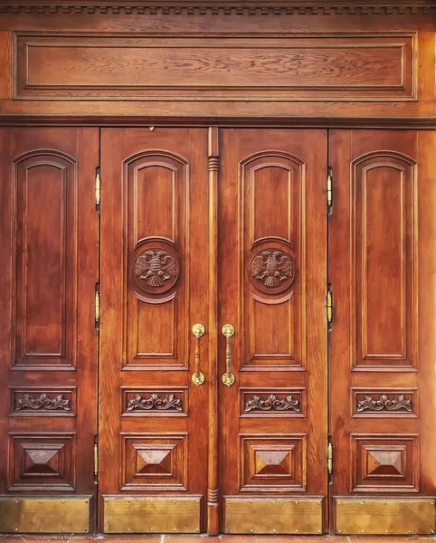 A wooden door with the state symbols of an old house in Russia (Filtered image, processed with a vintage effect).