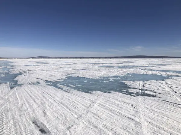 Frozen Lake Baikal, the deepest and largest freshwater lake by volume in the world, located in southern Siberia, Russia