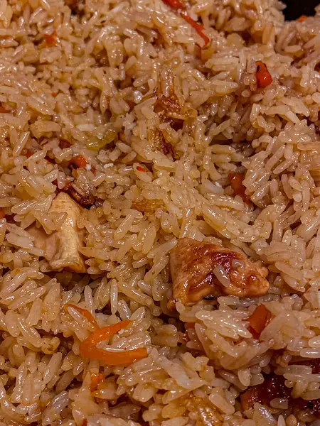 Rice with meat and mushrooms as a background. Close-up.