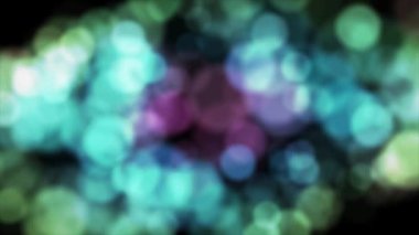 Canlandırılmış Renkli yavaş hareket eden bulanık parçacıklar bokeh etkisi arka planı, çok renkli ışık siyah arkaplan sızdırır