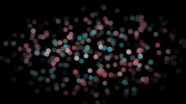 Canlandırılmış kırmızı ve turkuaz bulanık soyut parçacıklar yavaşça siyah arkaplan üzerinde hareket ediyor