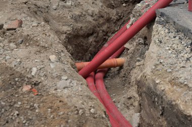 Kırmızı borular ve borular yerde yatıyor.