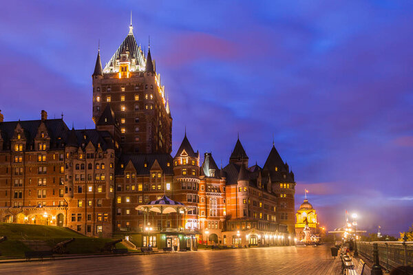 View of the Frontenac Castle and Dufferin Terrace at twilight, Quebec City, Quebec, Canada. The castle is a grand hotel and the most famous landmark of Quebec City.