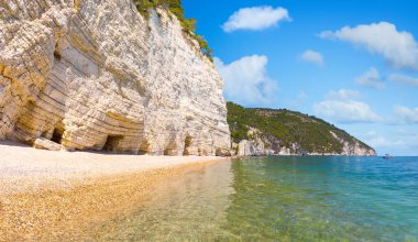 Güçlü ve beyaz kaya duvarları ünlü Baia delle Zagare (Zagare Körfezi) veya Baia dei Mergoli (Mergoli Körfezi) ile Faraglioni di Puglia, Gargano Ulusal Parkı, Puglia, İtalya