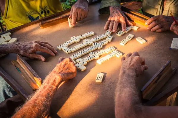 A group of elderly farmers playing dominoes in the country around Vinales, Cuba