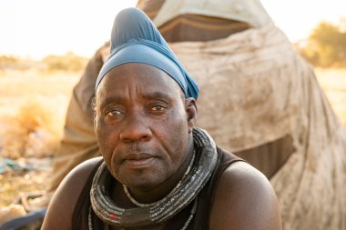 Portrait of a married Himba man living in Katutura, Windhoek, Komas Region, Namibia. In Himba culture, married men wear turbans as a symbol of their marital status. clipart