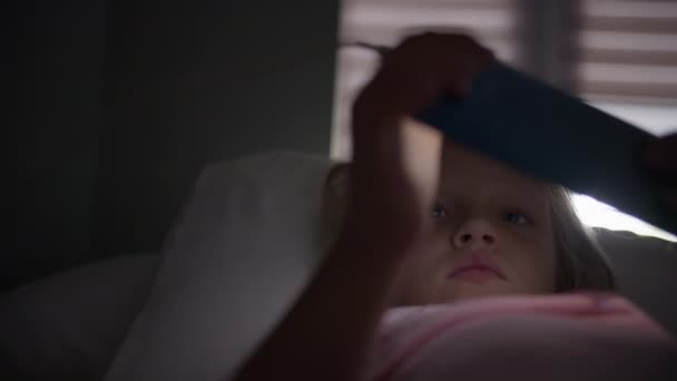 Ein Sechsjähriges Blondes Mädchen Liegt Auf Dem Bett Und Greift — Stockvideo