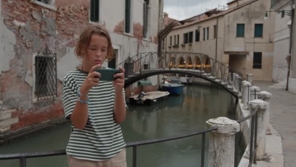 Teenager Holds Smartphone Venetian Canal Bridge Seen Background — Stock Video