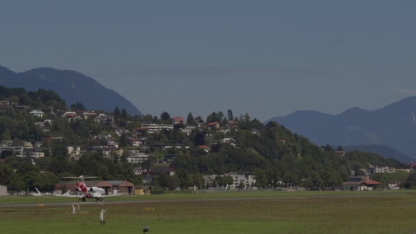 Plane Takes Airfield Background Residential Buildings Hillside Foreground Wind Pole — Stock Video