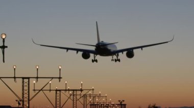 Alacakaranlıkta pist ışıklarıyla son yaklaşan uçak.