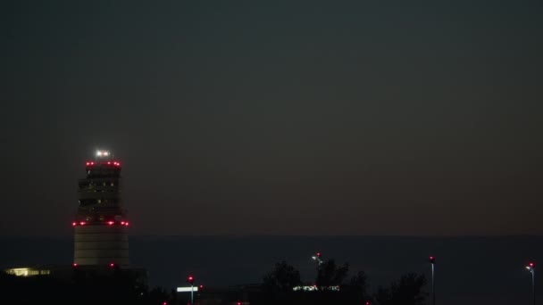 Airliner Illuminated Landing Lights Flies Low Night Control Tower Red — Stock Video