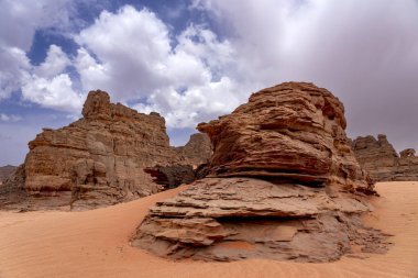 The Tadrart Rouge means Red Mountain. It is a mountain range in southeastern Algeria. The area has a rich array of rock art. clipart