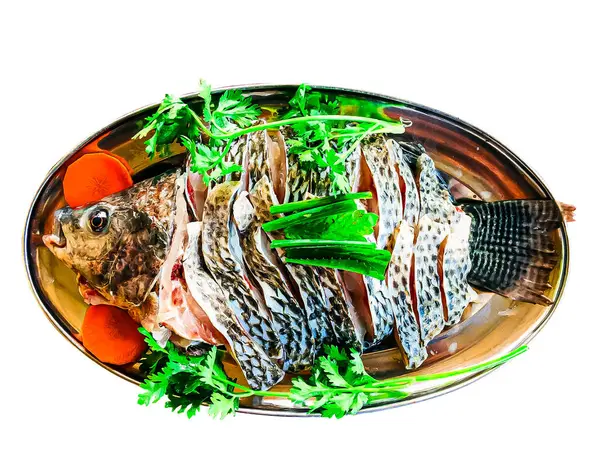 A cut-out image of fish on a plate with vegetables in a restaurant with clipping path