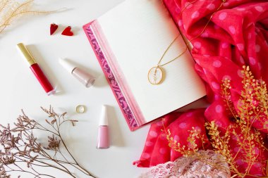 Kozmetik ürünleri ile güzellik kolajı ve beyaz arka plan üzerine açık bir kitap. Düz yerde, üst tarafta. Modern kadın konsepti. 