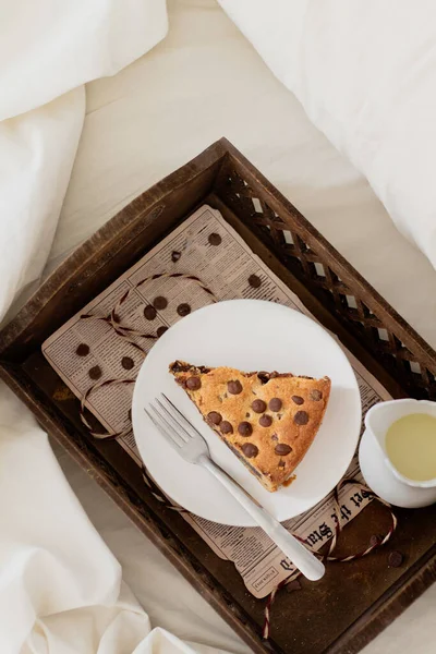 slice of cookie pie in wooden tray on bed. Breakfast concept.