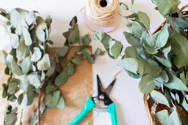 Minimal Florist Workspace Pruner Sisal Craft Paper Eucalyptus Branches White — Stock Photo, Image