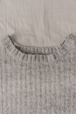 Gri kazak beyaz arka planda izole edilmiş. Kış moda konsepti.