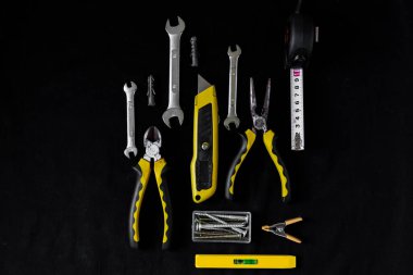 Maintenance, construction tools on black, dark background. clipart