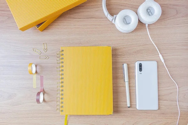 Workspace Mustard Planner Headphone Smartphone Pen Paper Clips Wooden Background — Stock Photo, Image