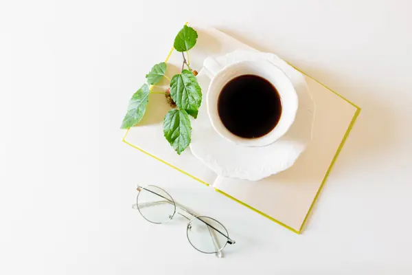 Vista Superior Xícara Café Preto Com Folhas Verdes Livro Branco — Fotografia de Stock