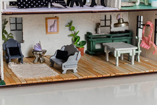 Kitchen and living room inside of Doll house. Miniature handmade house.