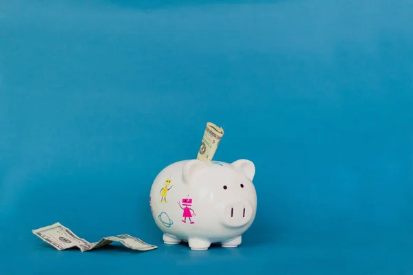 Piggy bank on blue background. Economy concept.