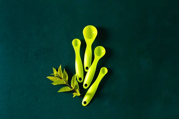 Kitchenware on dark green background. Flat lay, top view. All green composition.