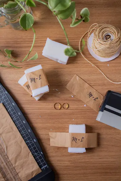 DIY Wedding Souvenirs - Coconut Soap, Golden Wedding Rings, Paper Cutter, Stamp on a Wooden Table