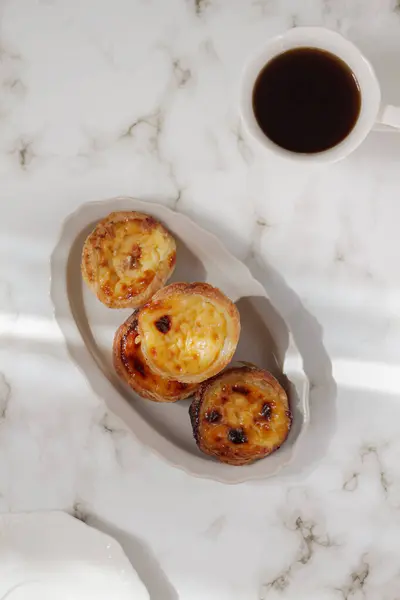 Nata Pastel. Food styling. Aesthetic composition.  Cup of coffee with egg tart dessert