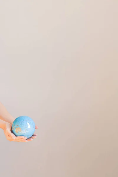 Young female hands holding the earth model