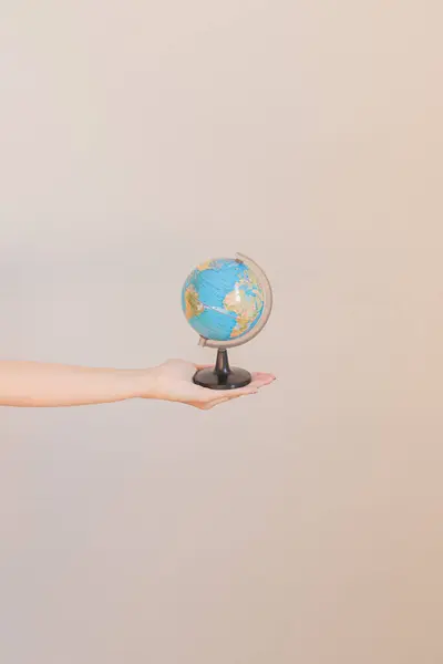 Young female hand holding the earth model