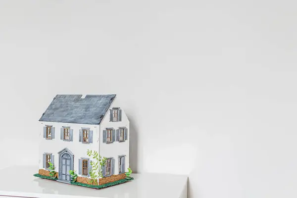 Doll house. Miniature handmade house on white background