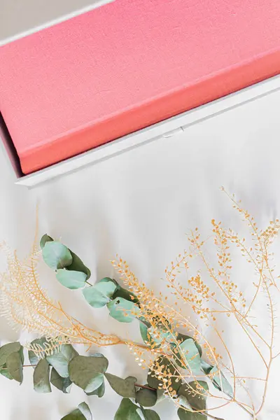 Pink Photo Album Dried Flowers Eucalyptus Leaves White Bed Sheet — Stock Photo, Image