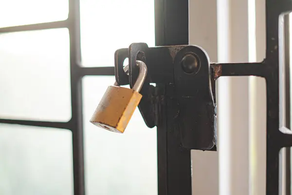 Stock image Golden Lock on Metal Gate with Bright Sunlight Background