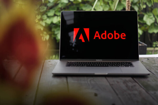 WROCLAW, POLAND - SEPTEMBER 14, 2023:Adobe logo, American computer software company (Adobe Photoshop, Adobe Illustrator, Adobe Acrobat, Adobe Creative Suite, PDF), displayed on a MacBook Pro screen
