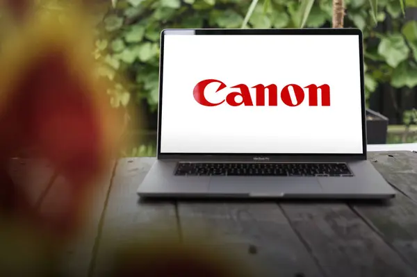 Stock image WROCLAW, POLAND - NOVEMBER 22, 2023:Canon logo, Japanese corporation specializing in optical, imaging, and industrial products, displayed on MacBook Pro screen